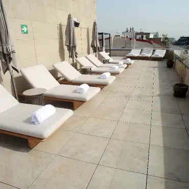 Hotel terrace with sun loungers on large-format Access Safety flooring