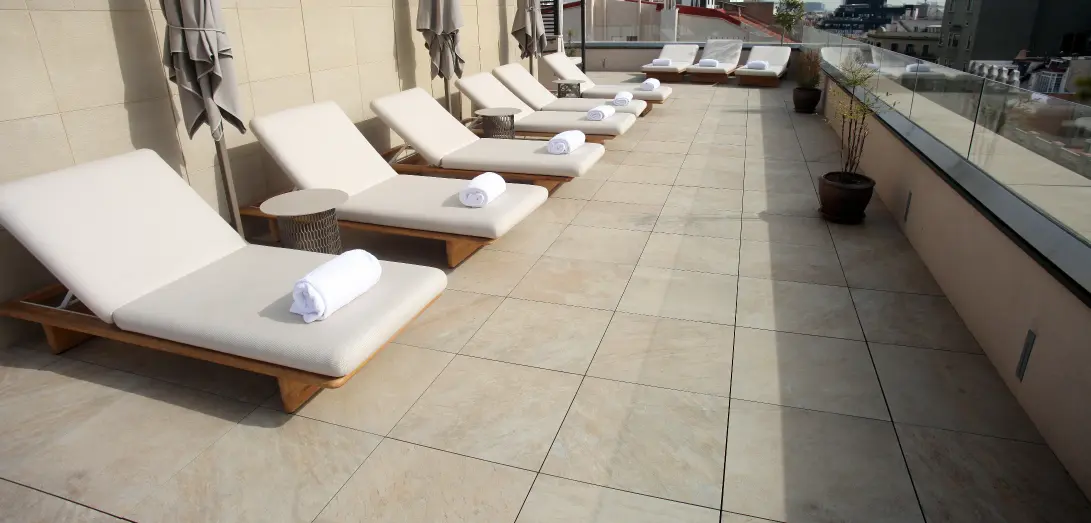 Hotel terrace with sun loungers on large-format Access Safety flooring