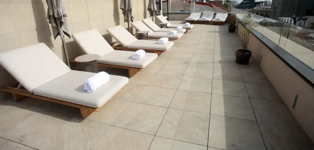 Hotel terrace with sun loungers on large-format Access Safety flooring